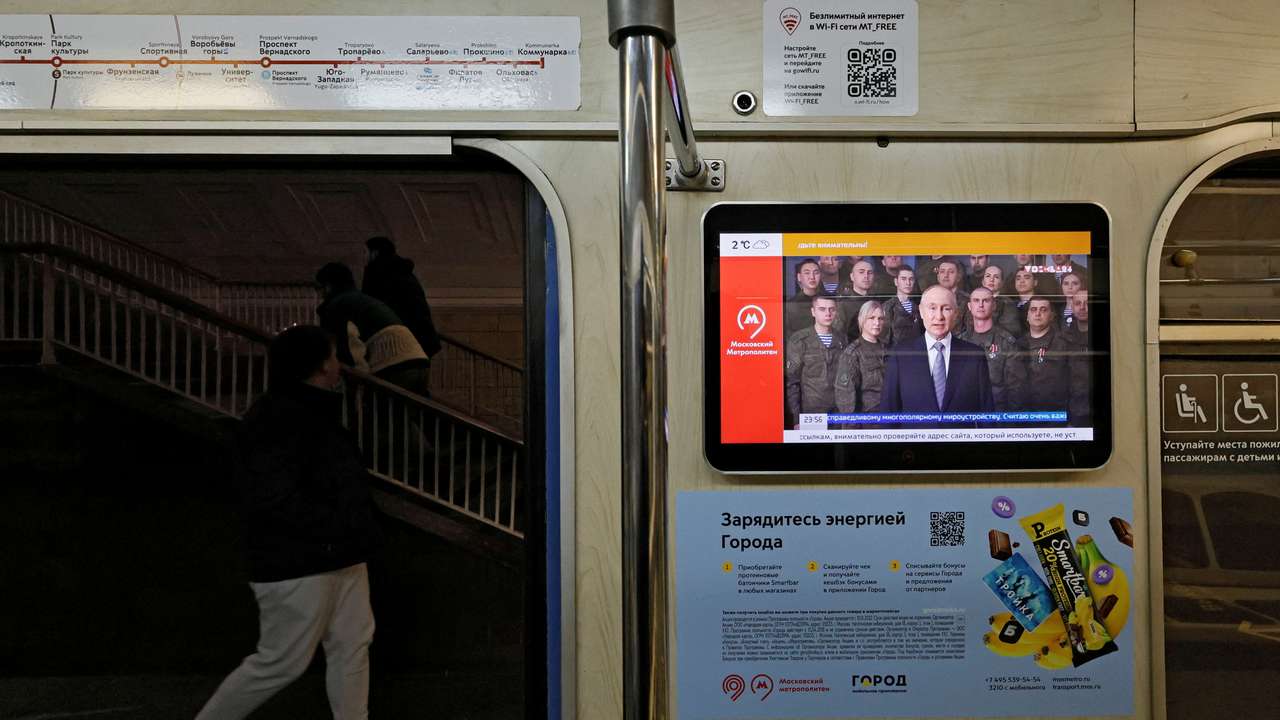 A view shows a screen broadcasting Russian President Vladimir Putin's annual New Year address to the nation, in a subway train in Moscow