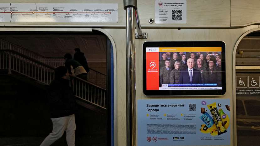 A view shows a screen broadcasting Russian President Vladimir Putin's annual New Year address to the nation, in a subway train in Moscow