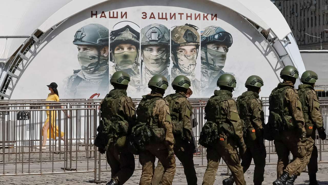 FILE PHOTO: Russian army servicemen walk at an exhibition displaying armoured vehicles and equipment captured by the Russian army from Ukrainian forces