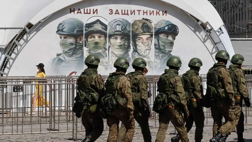 FILE PHOTO: Russian army servicemen walk at an exhibition displaying armoured vehicles and equipment captured by the Russian army from Ukrainian forces
