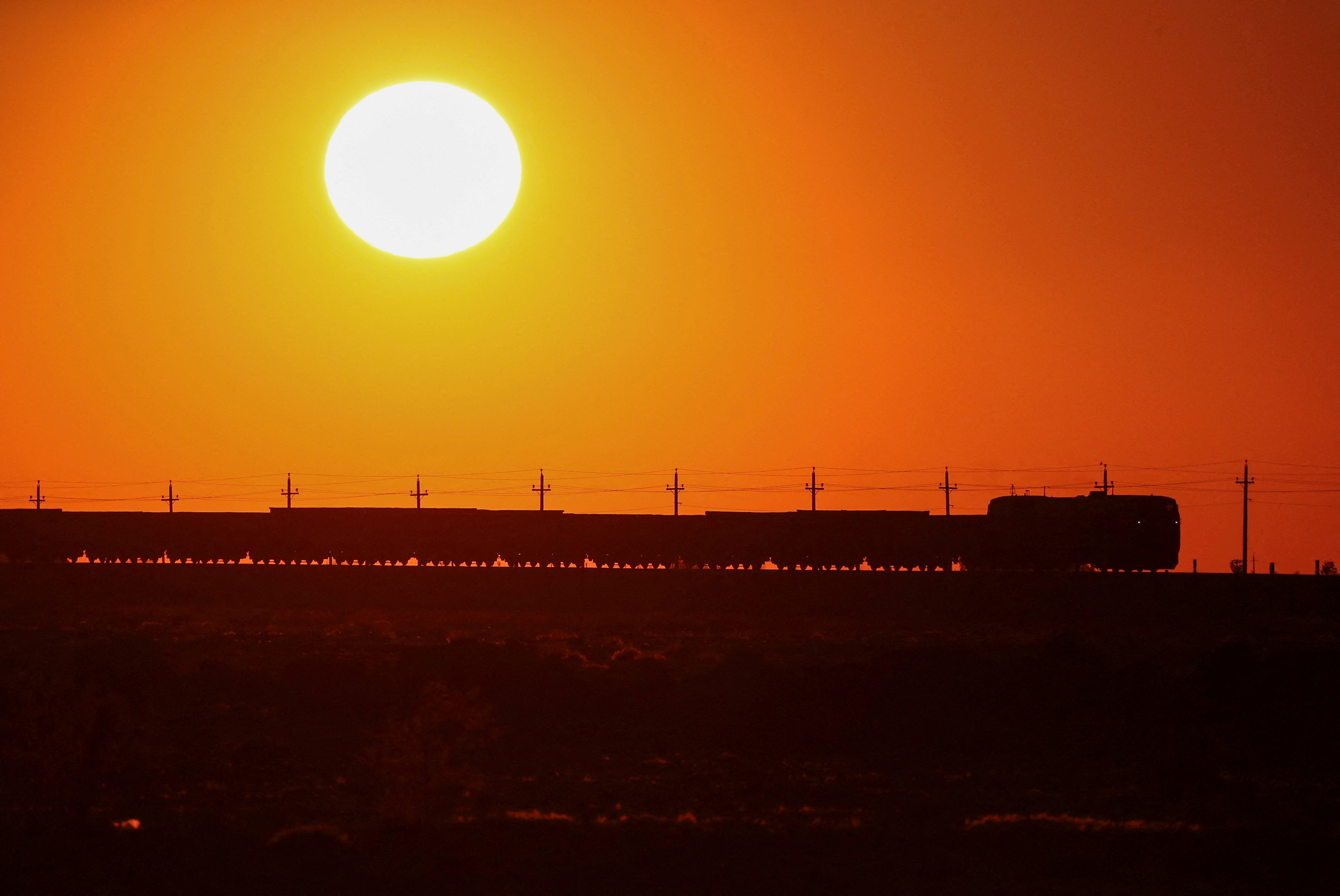 FILE PHOTO: A freight train moves during sunset in the Almaty region