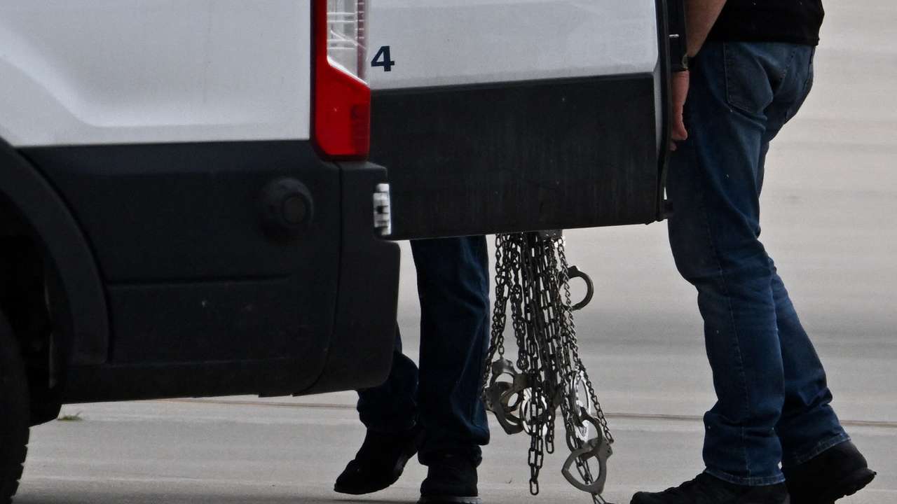 Migrants detained by U.S. Immigration and Customs Enforcement (ICE) board a plane at Gary/Chicago International Airport