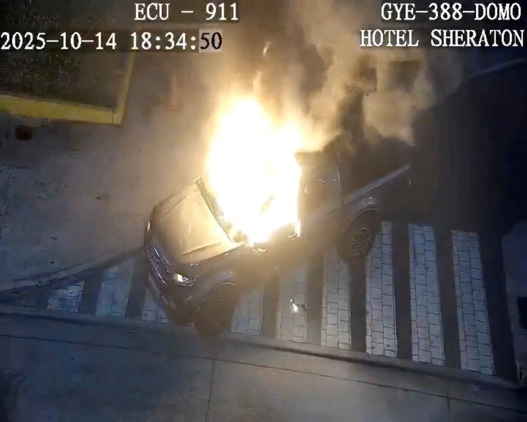 Flames rise from a vehicle that exploded outside a shopping mall, in Guayaquil