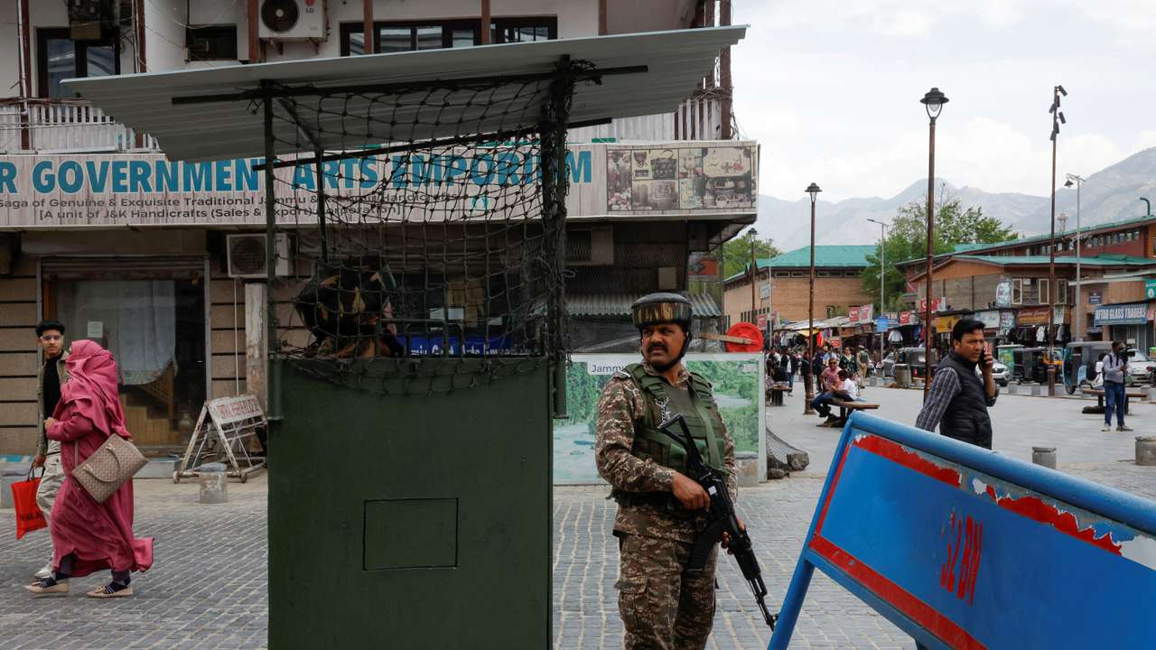 An Indian security force personnel stands guard in a street, following a suspected militant attack near south Kashmir's Pahalgam, in Srinagar