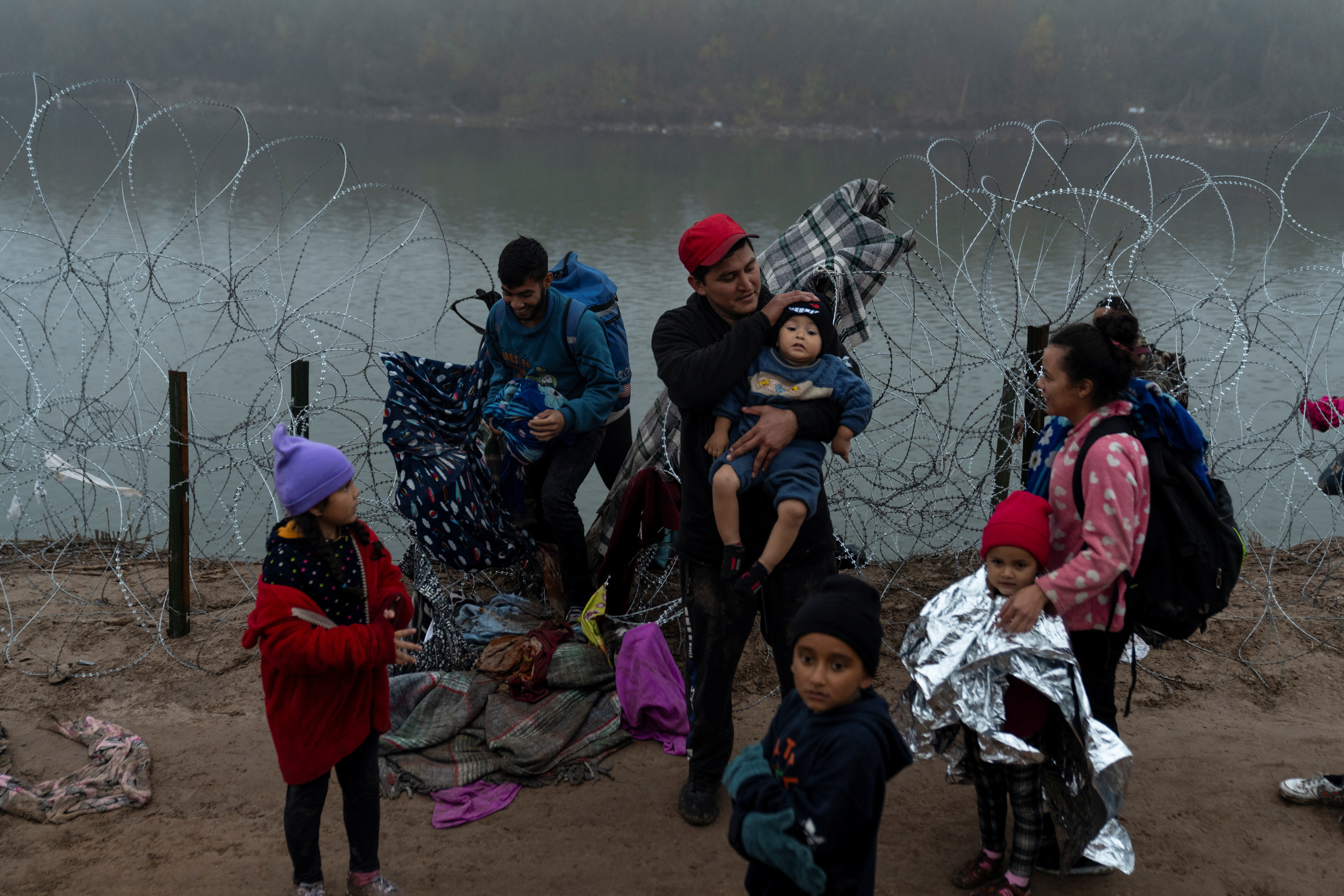 Migrants cross from Mexico into Eagle Pass, Texas