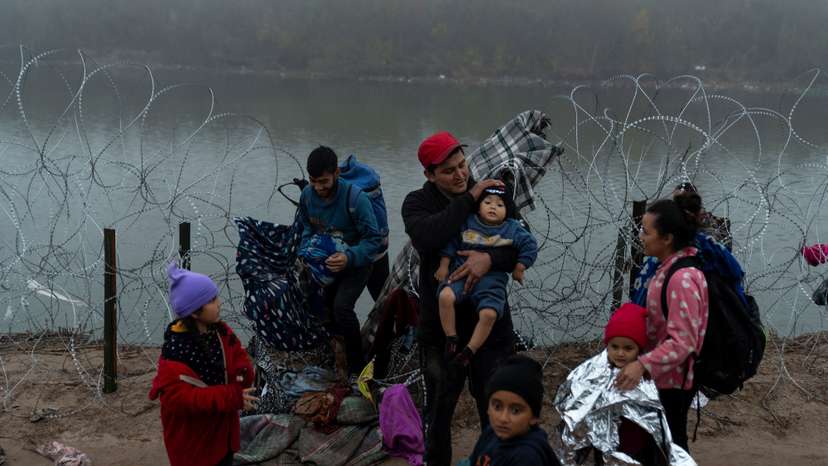 Migrants cross from Mexico into Eagle Pass, Texas