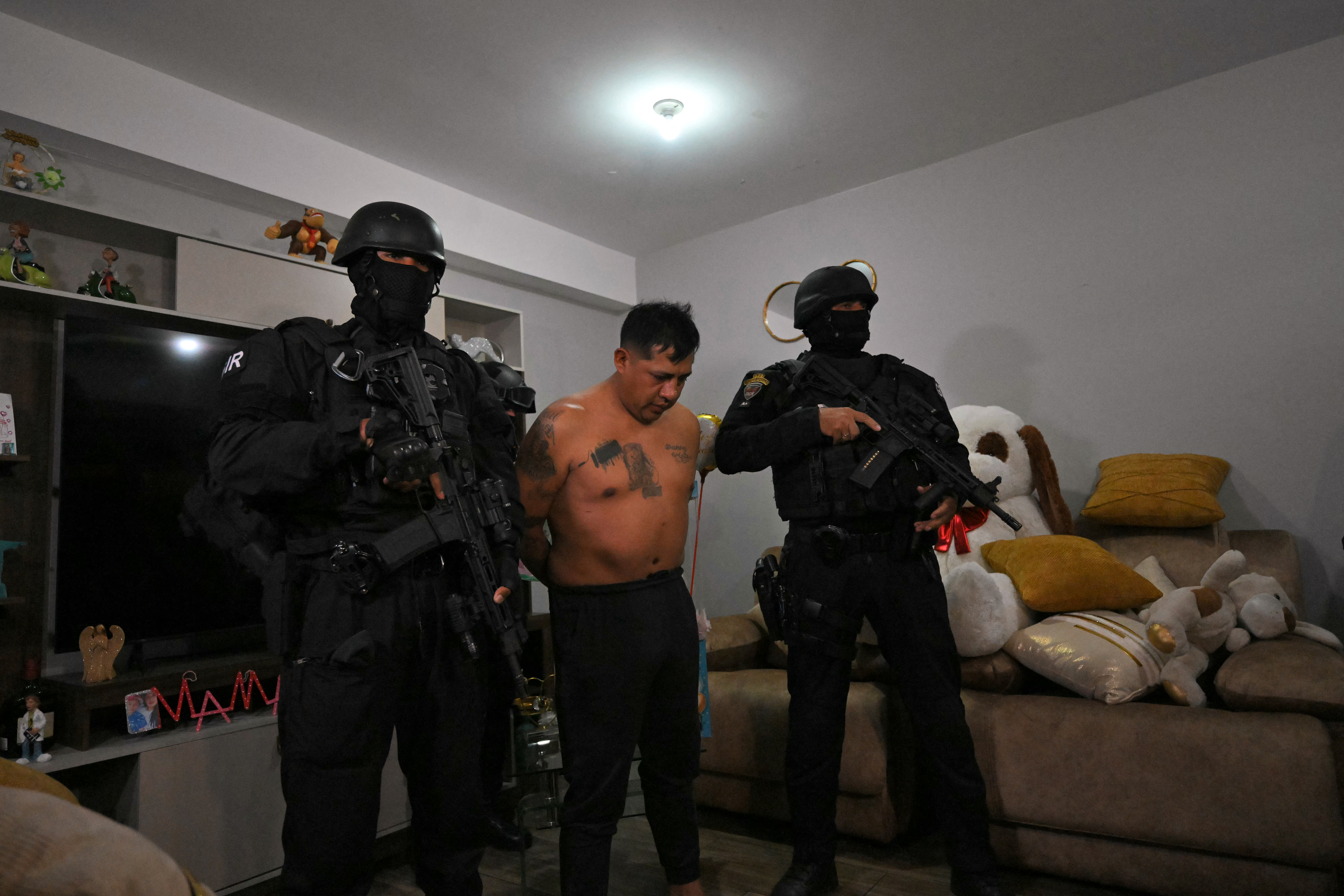 Police arrest Eduardo Gomez, alias "Gordo Paul", a leader of Los Lobos drug trafficking group, during a curfew imposed by Ecuador's President Daniel Noboa to tackle organized crime, in Quito in the early hours of May 14, 2026. Ecuador's police on May 14 captured a "dangerous" leader of Los Lobos, the country's largest drug trafficking group, in a cinematic operation led by Interior Minister Jhon Reimberg, AFP reporters witnessed. (Photo by AFP)
