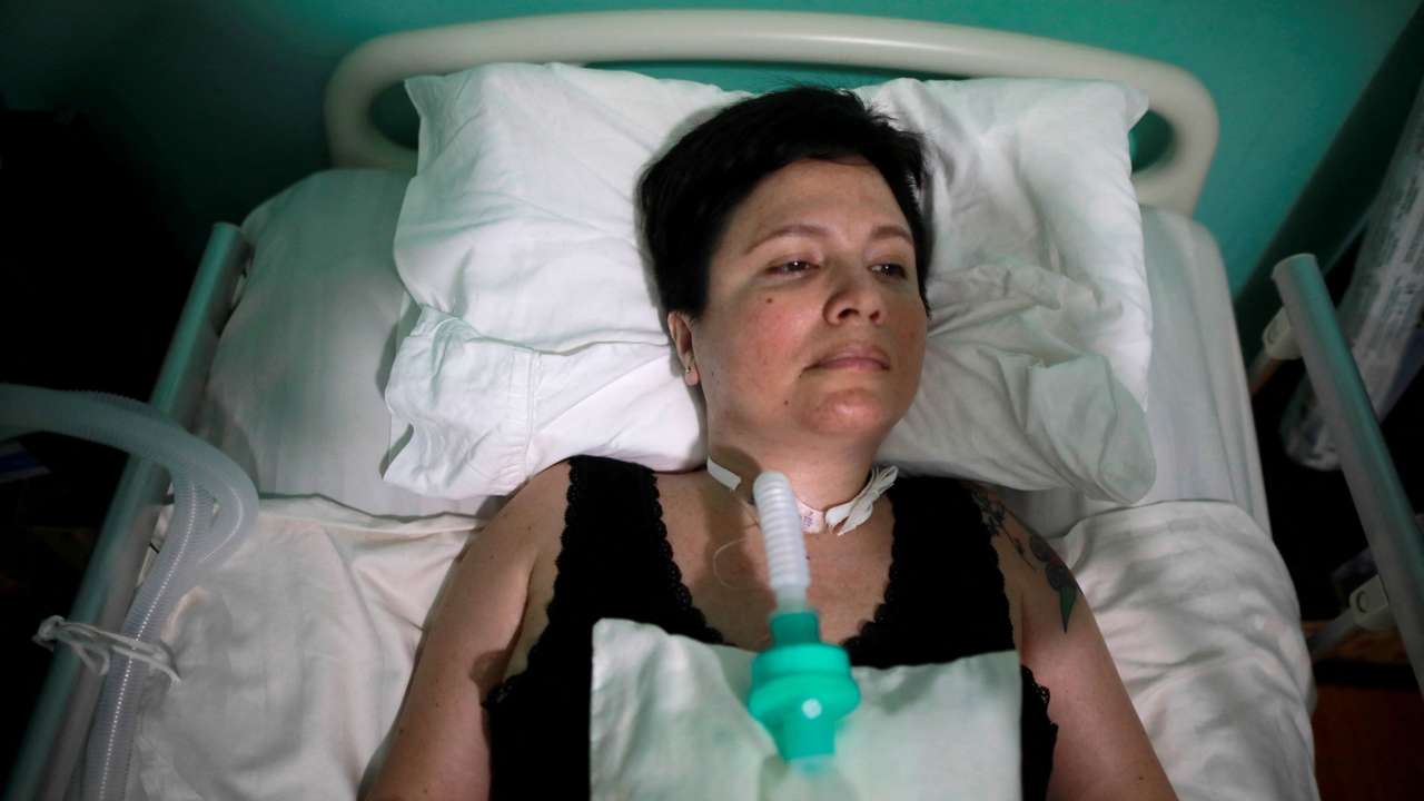 FILE PHOTO: Ana Estrada, a euthanasia advocate who suffers from an incurable condition, lies in bed at her home in Lima