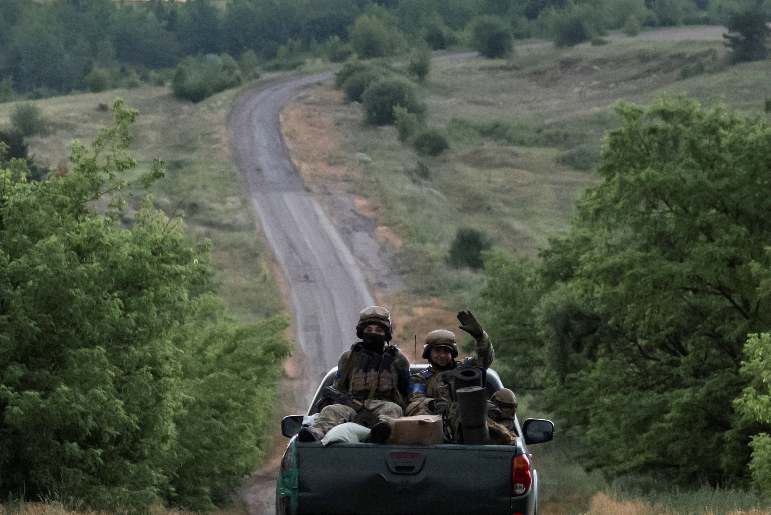 FILE PHOTO: Ukrainian servicemen ride pickup truck near the front line near the town of Vovchansk