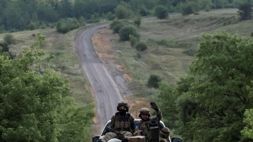 FILE PHOTO: Ukrainian servicemen ride pickup truck near the front line near the town of Vovchansk