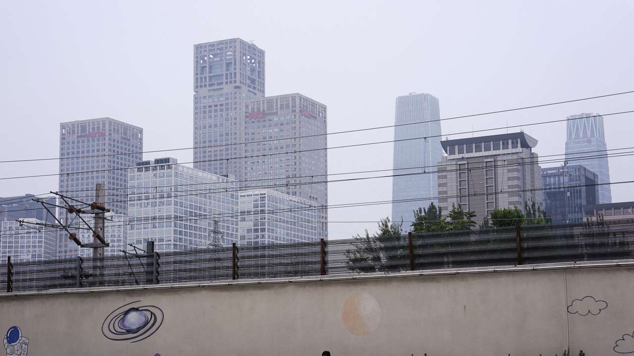 FILE PHOTO: Person sits on a bench near Beijing's Central Business District (CBD)