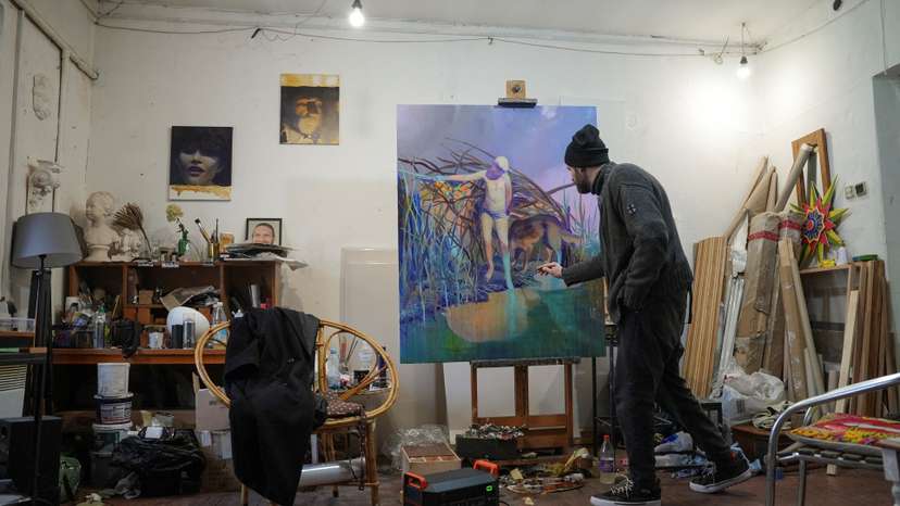 Ukrainian artist works at his studio during a power blackout in Kyiv