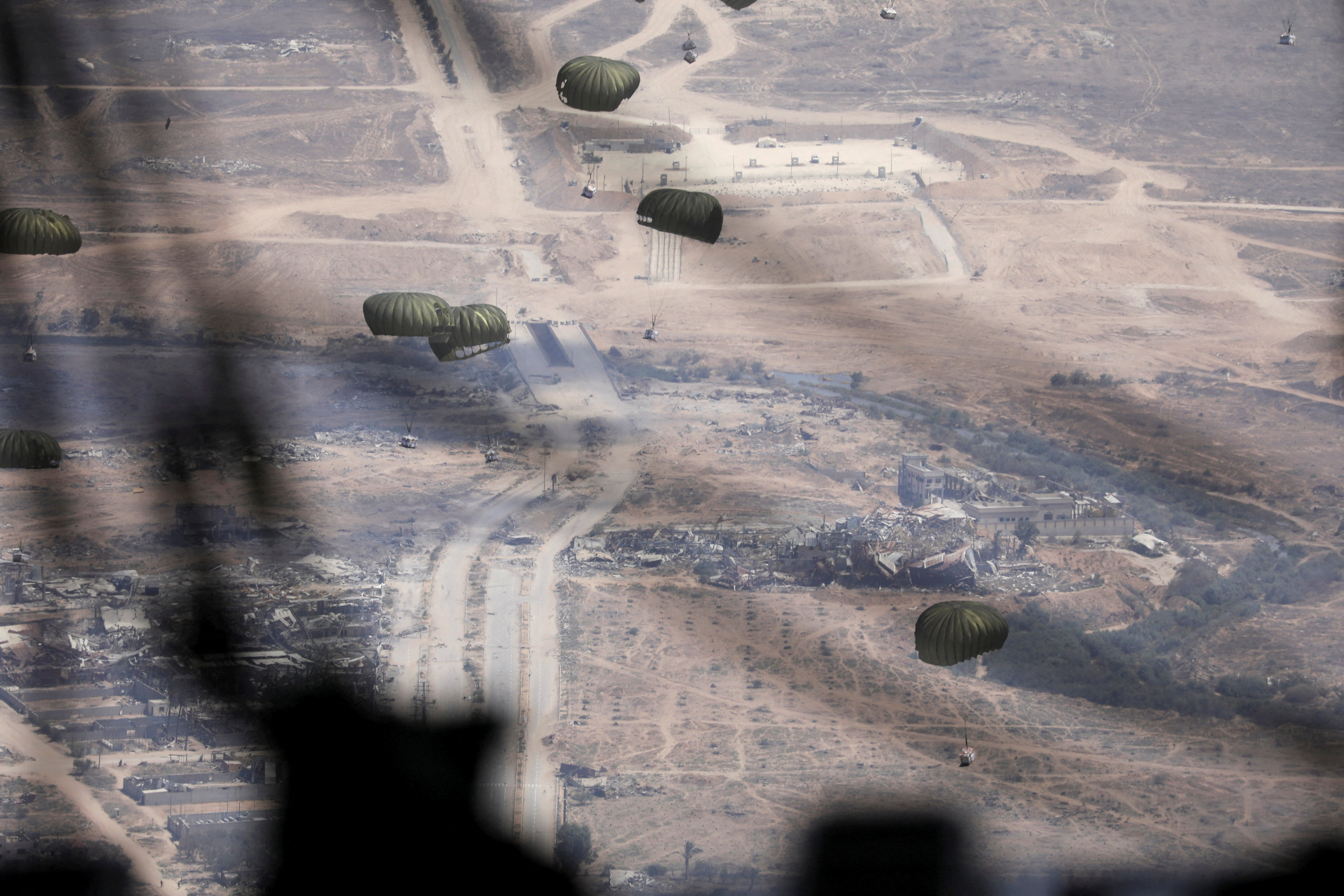 Jordanian military personnel airdrop aid parcels over Gaza
