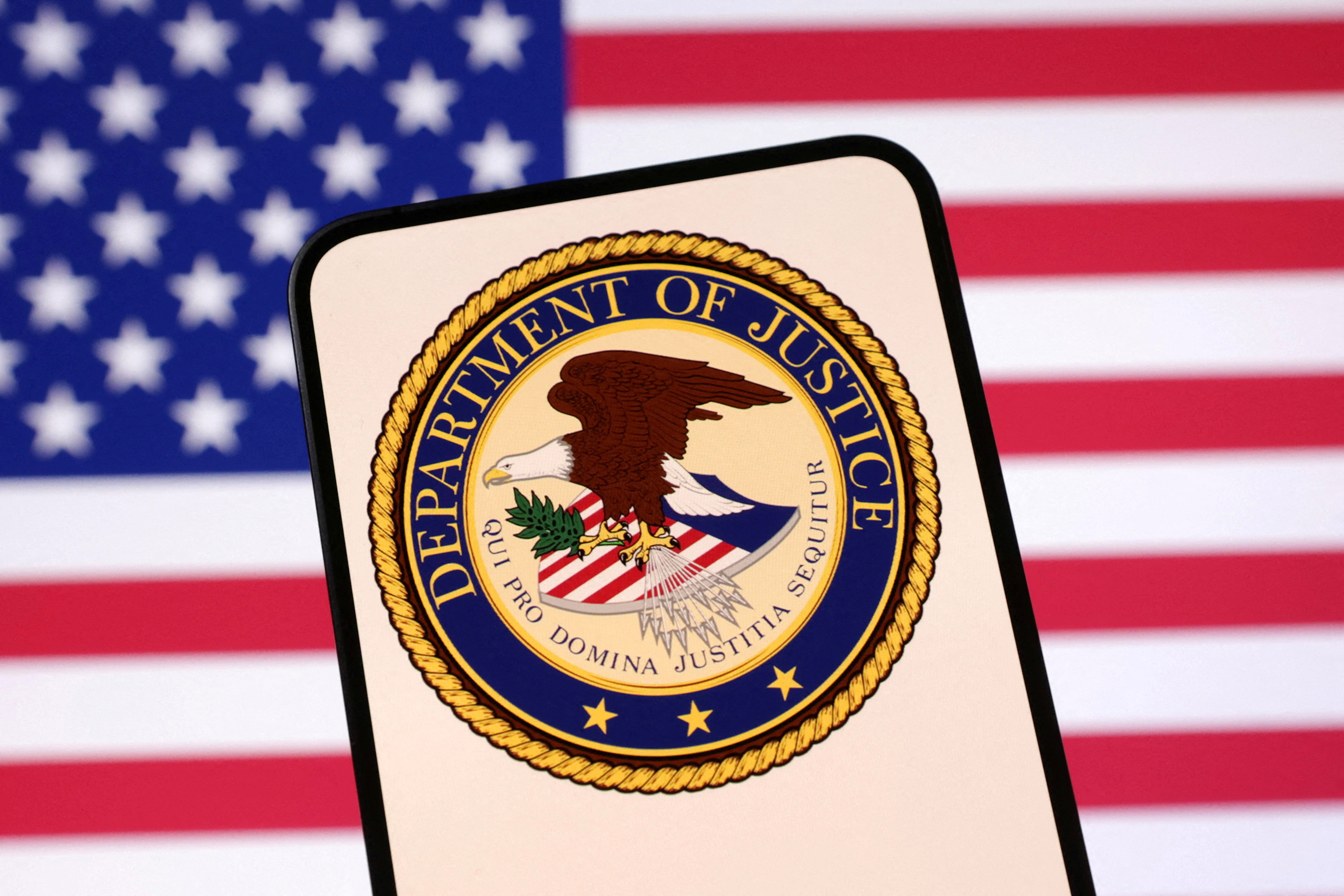 FILE PHOTO: Illustration shows United States Department of Justice logo and U.S. flag