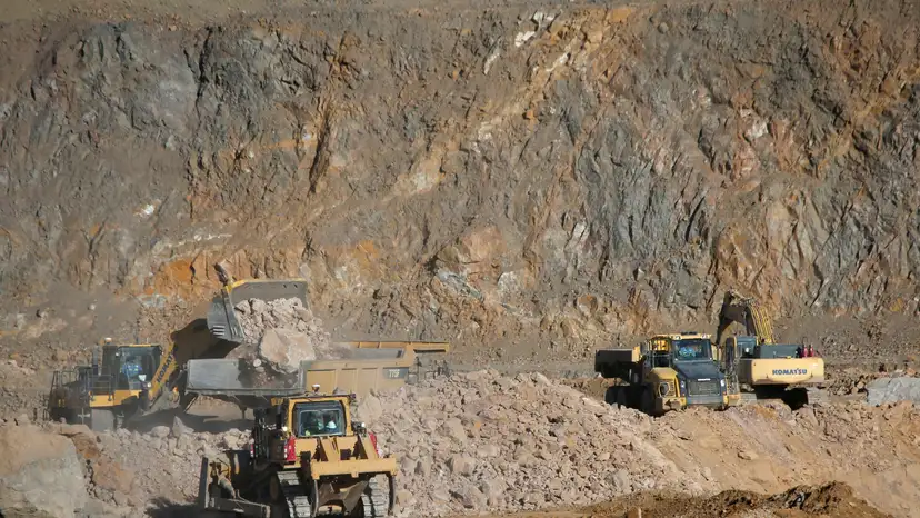 FILE PHOTO: Wheel loaders fill trucks with ore at the MP Materials rare earth mine in Mountain Pass