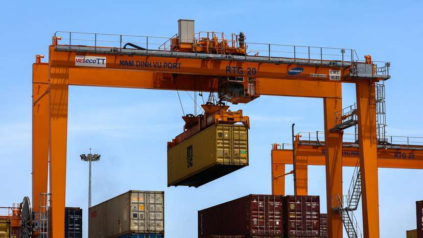 A container is loaded onto a cargo ship while docked at Hai Phong port in Vietnam