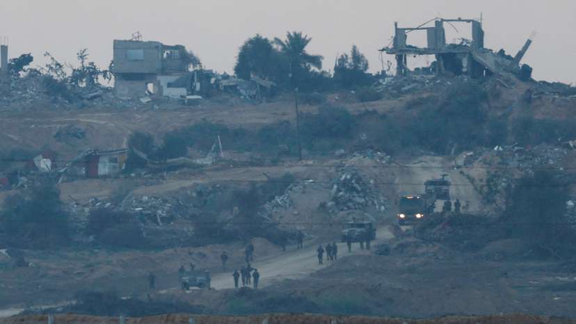 Israeli soldiers and vehicles move inside Gaza near the border with Israel