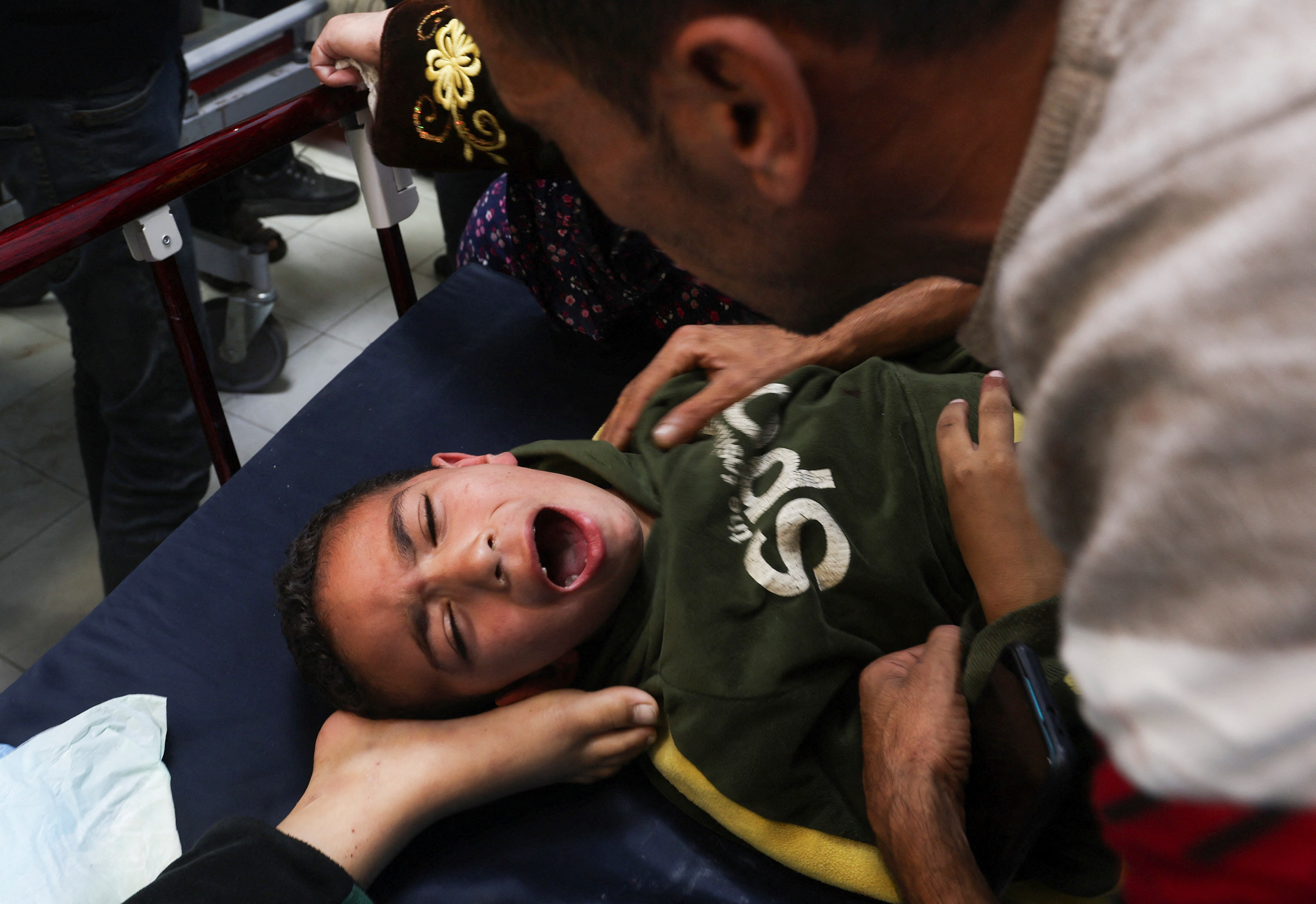 A Palestinian boy is assisted following an Israeli strike strike at Nasser hospital in Khan Younis