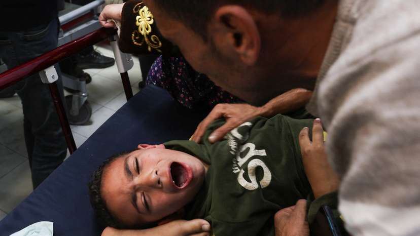 A Palestinian boy is assisted following an Israeli strike strike at Nasser hospital in Khan Younis