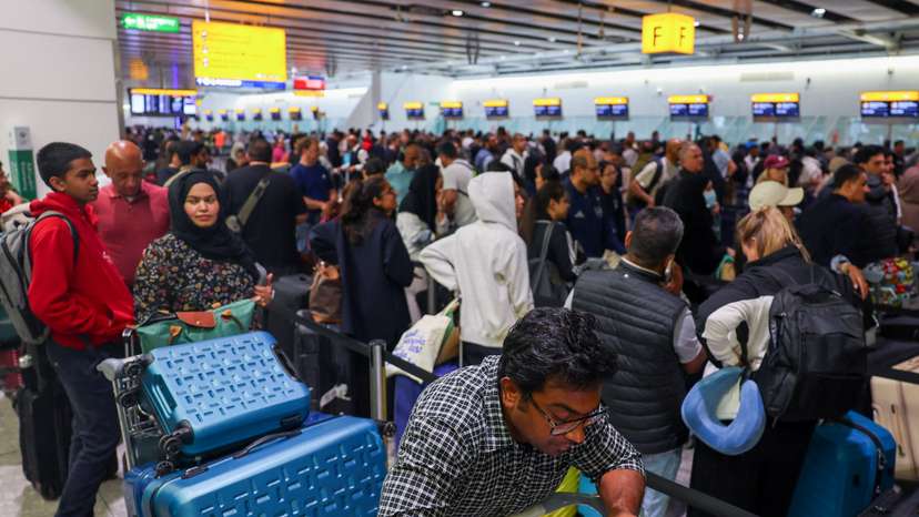 FILE PHOTO: Travellers at Heathrow Airport amid cyberattack disruptions, in Greater London