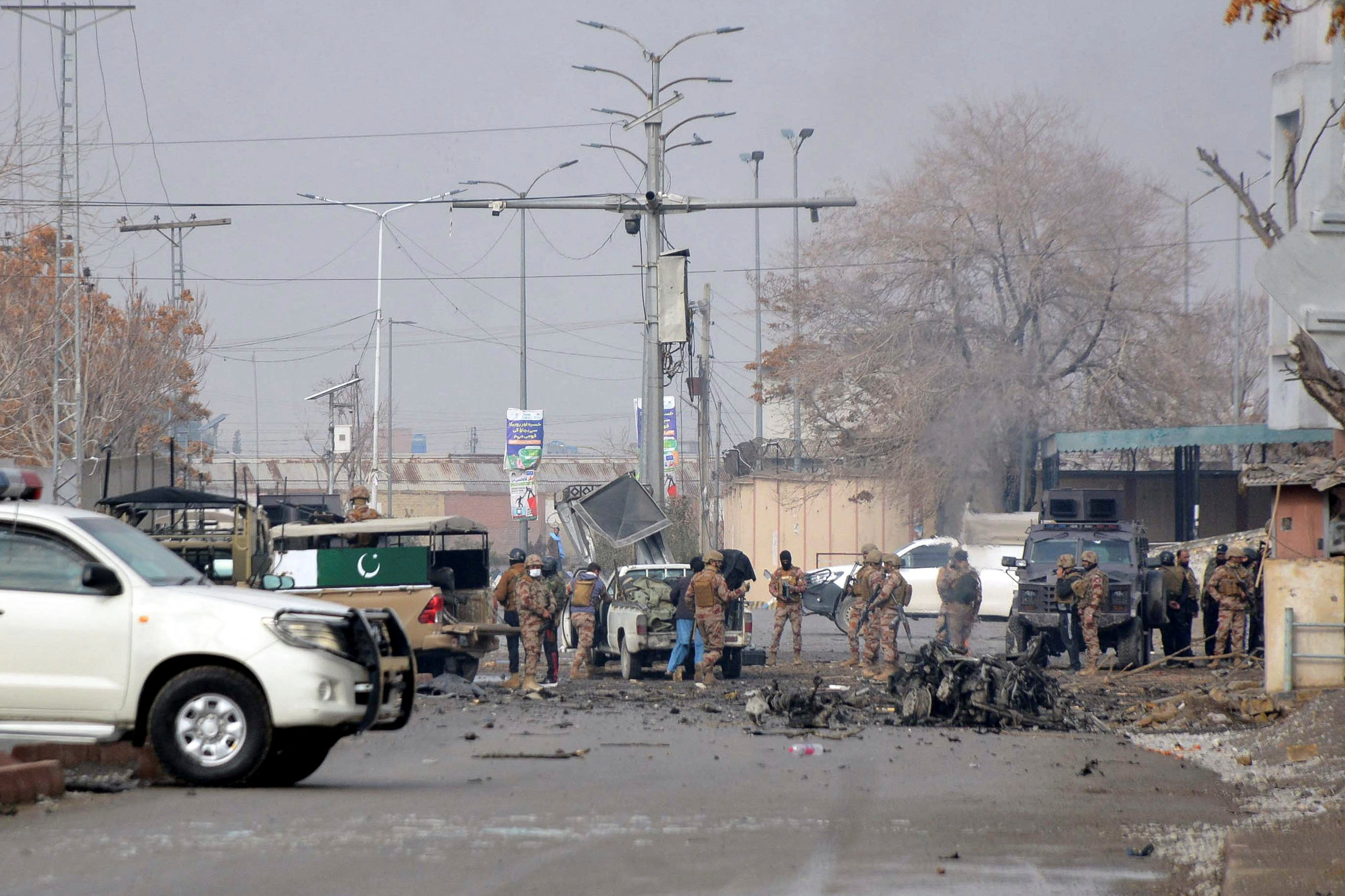 Army soldiers gather at the site, following millitant attacks, in Quetta