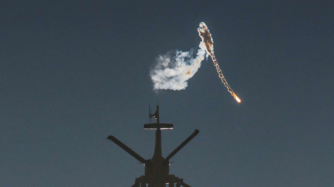 An Israeli military helicopter releases a flare over the Israel-Gaza border, after a temporary truce between Israel and the Palestinian Islamist group Hamas expired, as seen from southern Israel