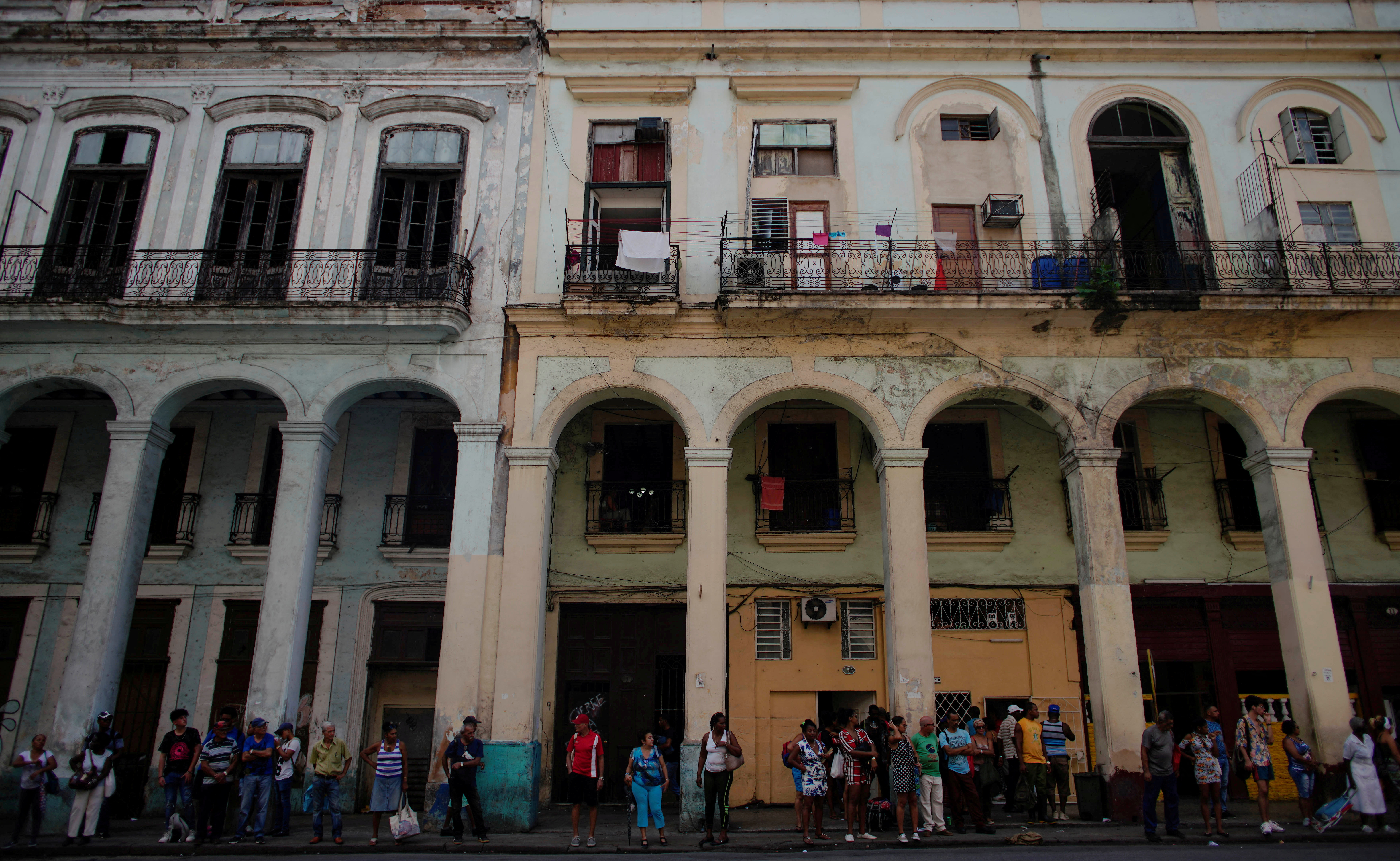 FILE PHOTO: People wait for public transportation in Havana