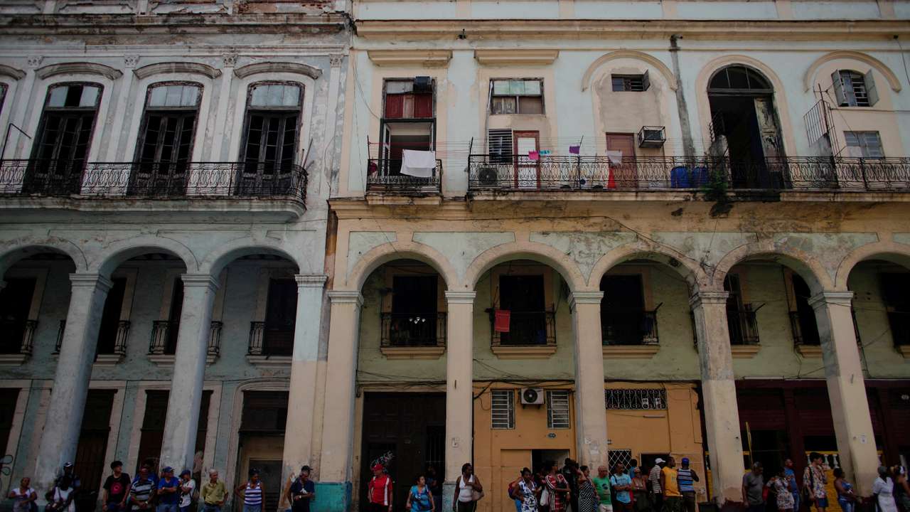 FILE PHOTO: People wait for public transportation in Havana
