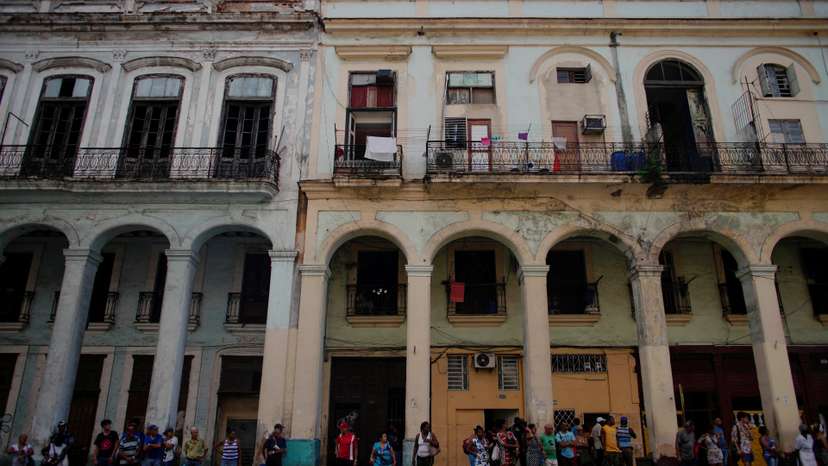 FILE PHOTO: People wait for public transportation in Havana
