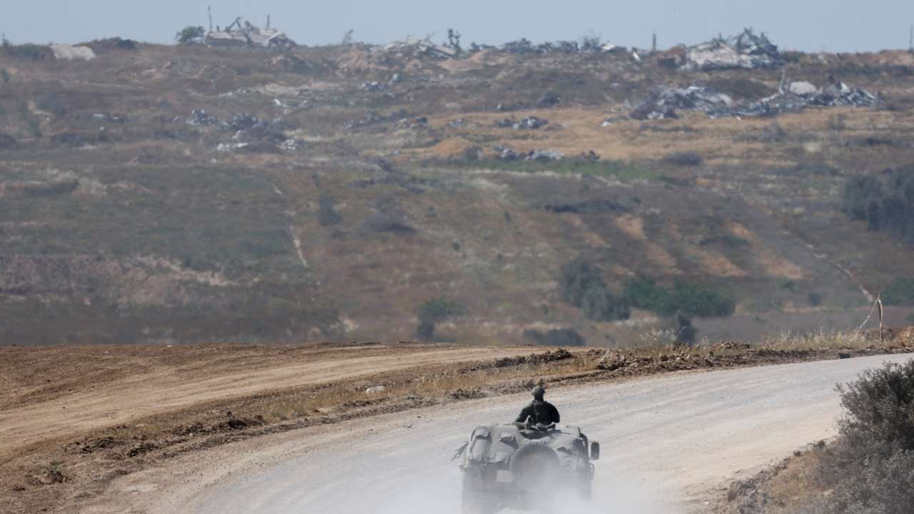 Israeli military vehicles manoeuvre, near the Israel-Gaza border