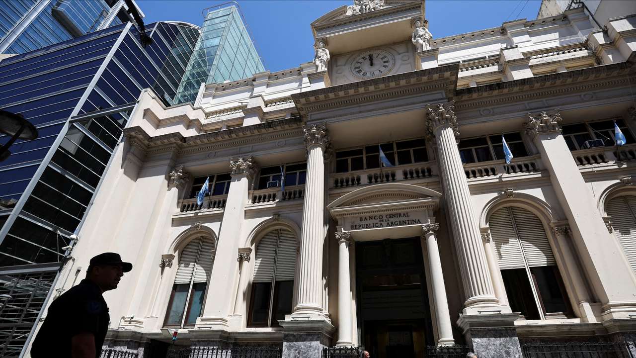 FILE PHOTO: Pedestrians walk past the facade of Argentina's Central Bank, in Buenos Aires