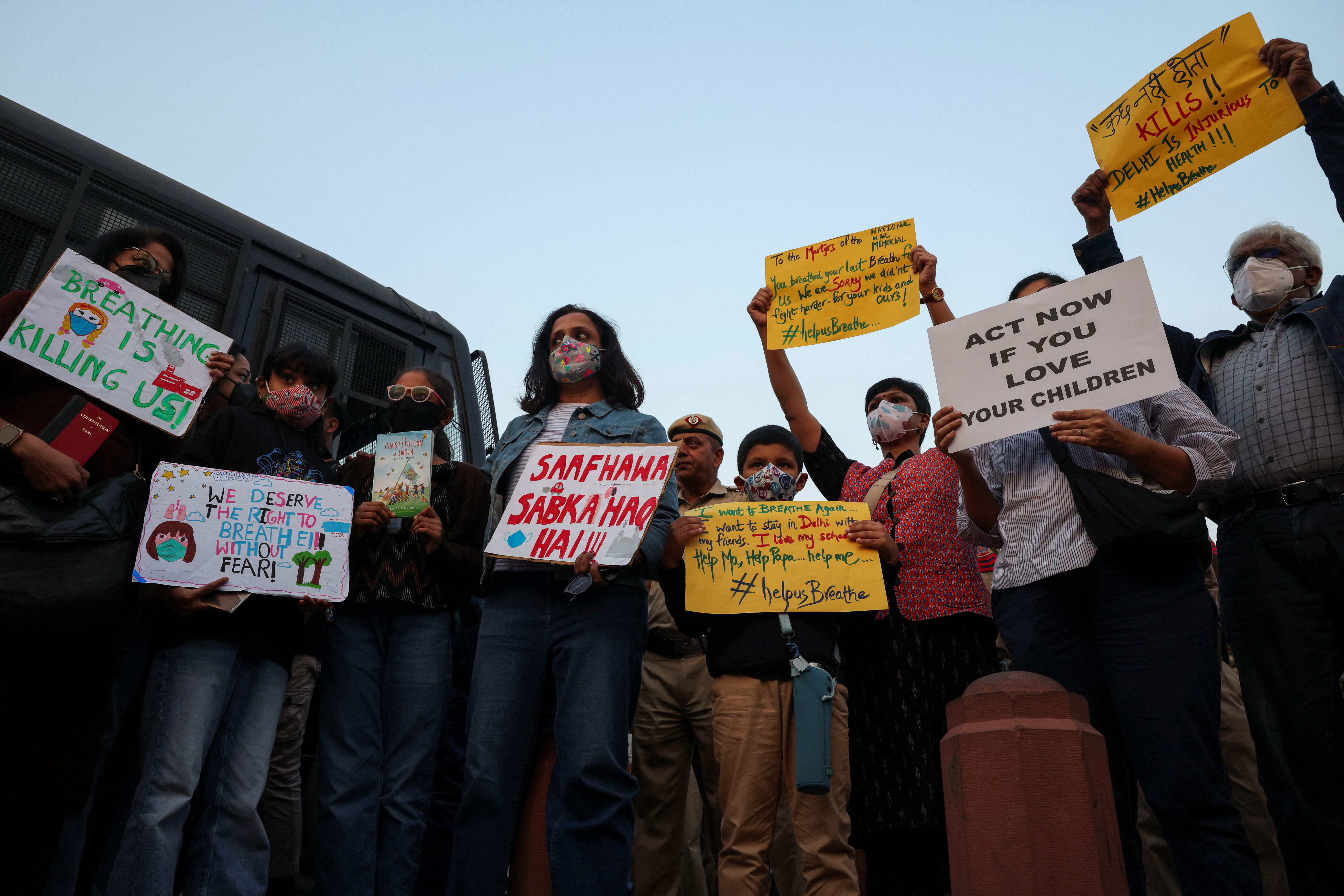 Protesters hold placards in front of the India Gate during a protest against air pollution in New Delhi