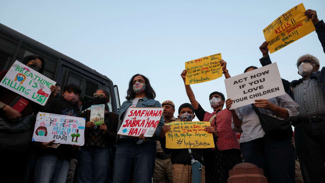 Protesters hold placards in front of the India Gate during a protest against air pollution in New Delhi