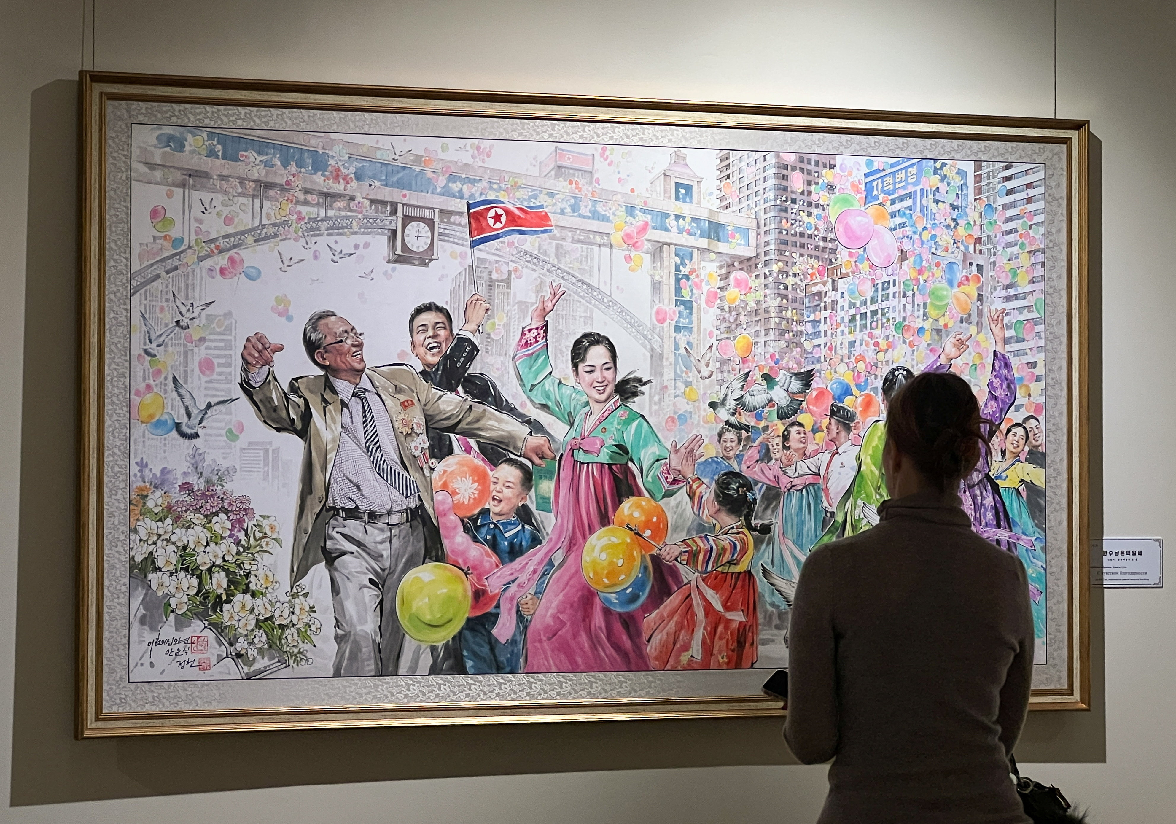 People visit an exhibition of North Korean art in Moscow