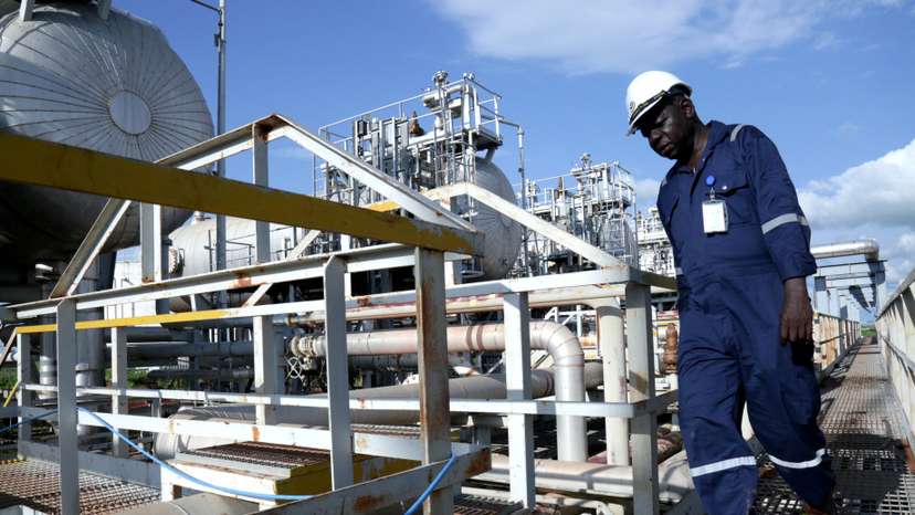 FILE PHOTO: A worker walks by an oil well at the Toma South oil field to Heglig, in Ruweng State