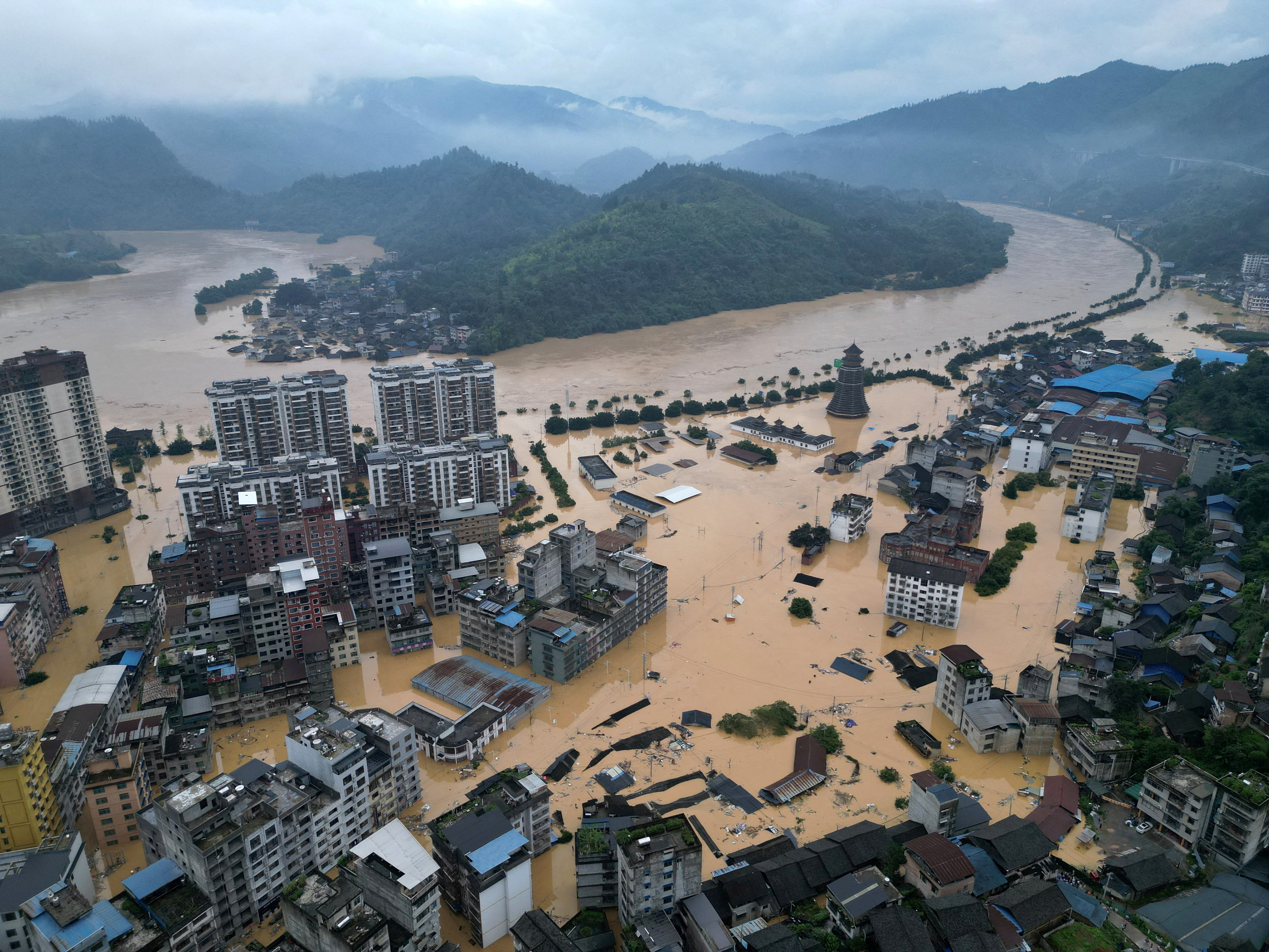 Drone view shows buildings and roads are half submerged in floodwaters after heavy rainfalls, in Rongjiang
