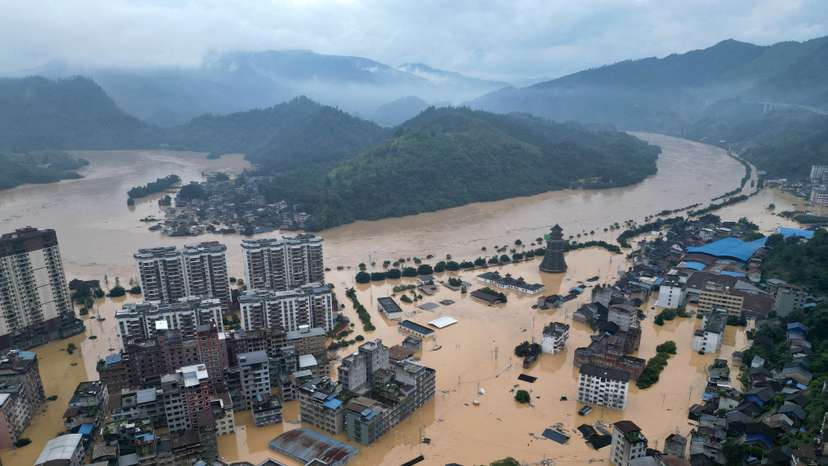 Drone view shows buildings and roads are half submerged in floodwaters after heavy rainfalls, in Rongjiang