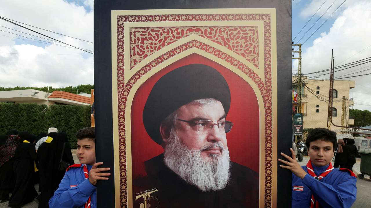 FILE PHOTO: Boys scouts carry a picture of Hezbollah leader Sayyed Hassan Nasrallah in Kfar Melki