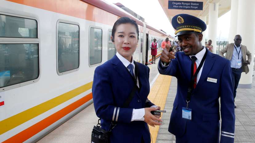 FILE PHOTO: Kenya Railways attendants talk next to a train along the Standard Gauge Railway (SGR) line constructed by the China Road and Bridge Corporation (CRBC) and financed by Chinese government in Ongata Rongai