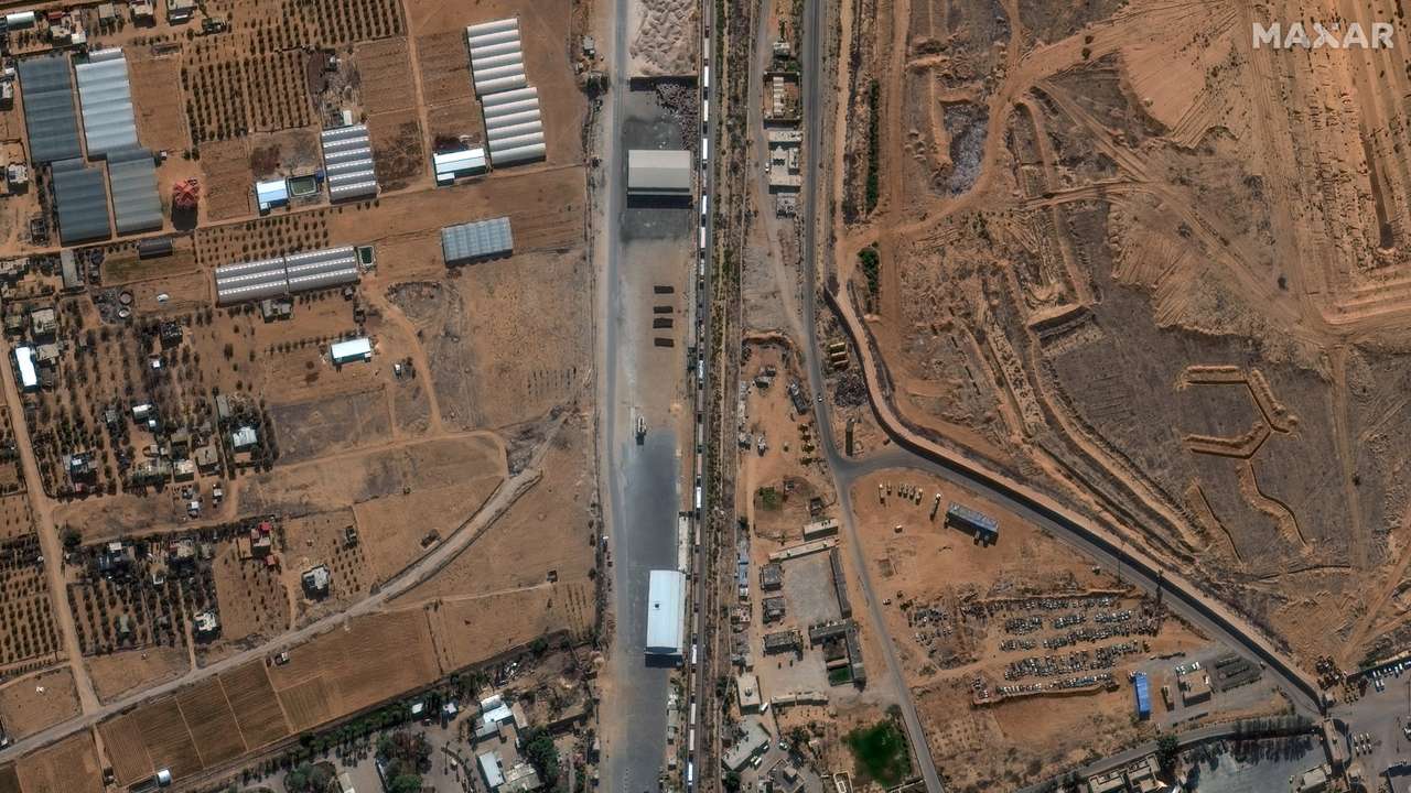 A satellite image shows humanitarian-associated trucks queueing to enter the Rafah border crossing