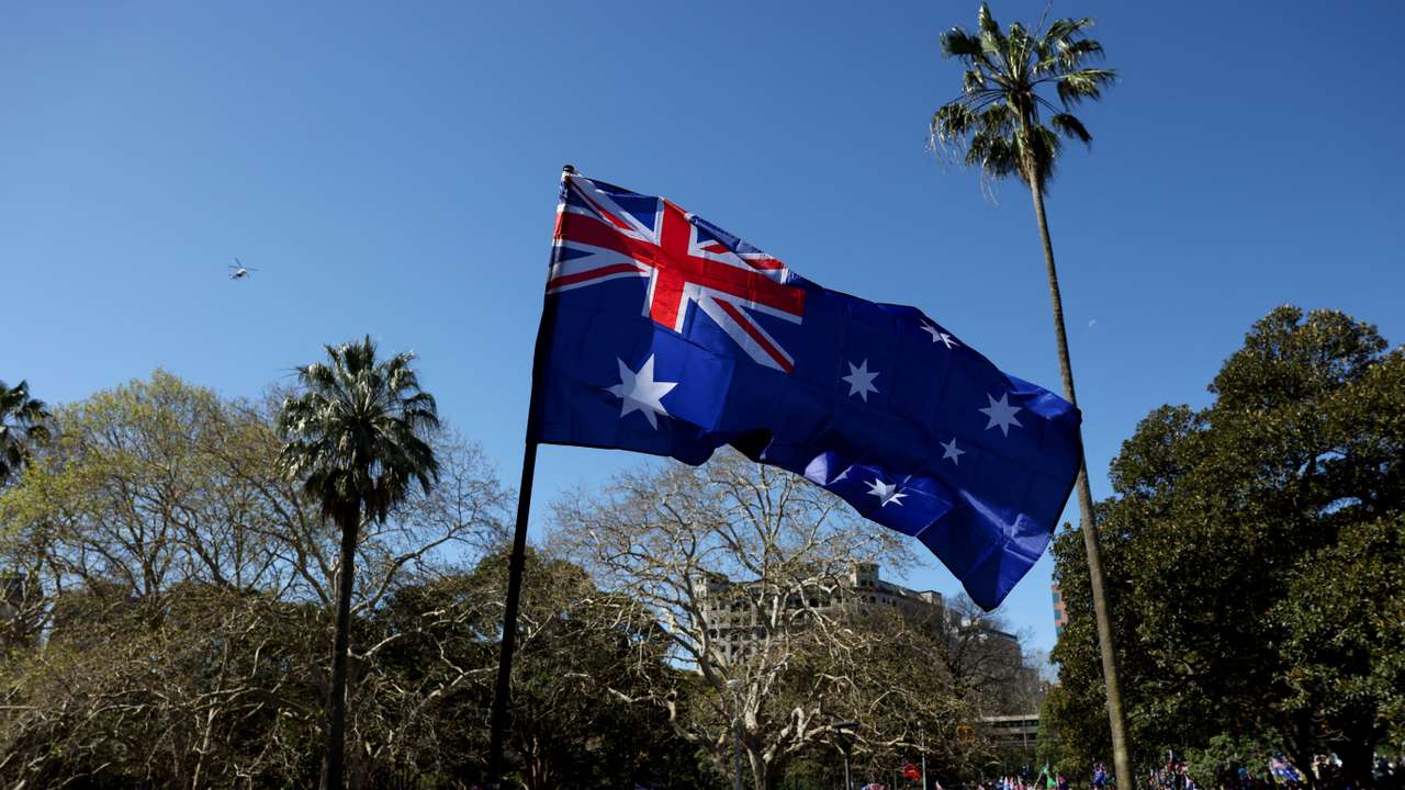 Demonstrators carry Australian flags during the ‘March for Australia’ anti-immigration protest in Sydney