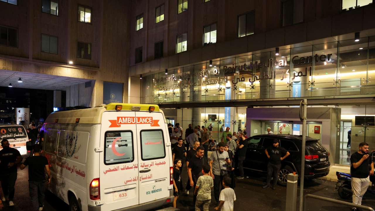 People walk near an ambulance outside American University of Beirut Medical Center, including Hezbollah fighters and medics, were wounded and killed when the pagers they use to communicate exploded across Lebanon, according to a security source, in Beirut