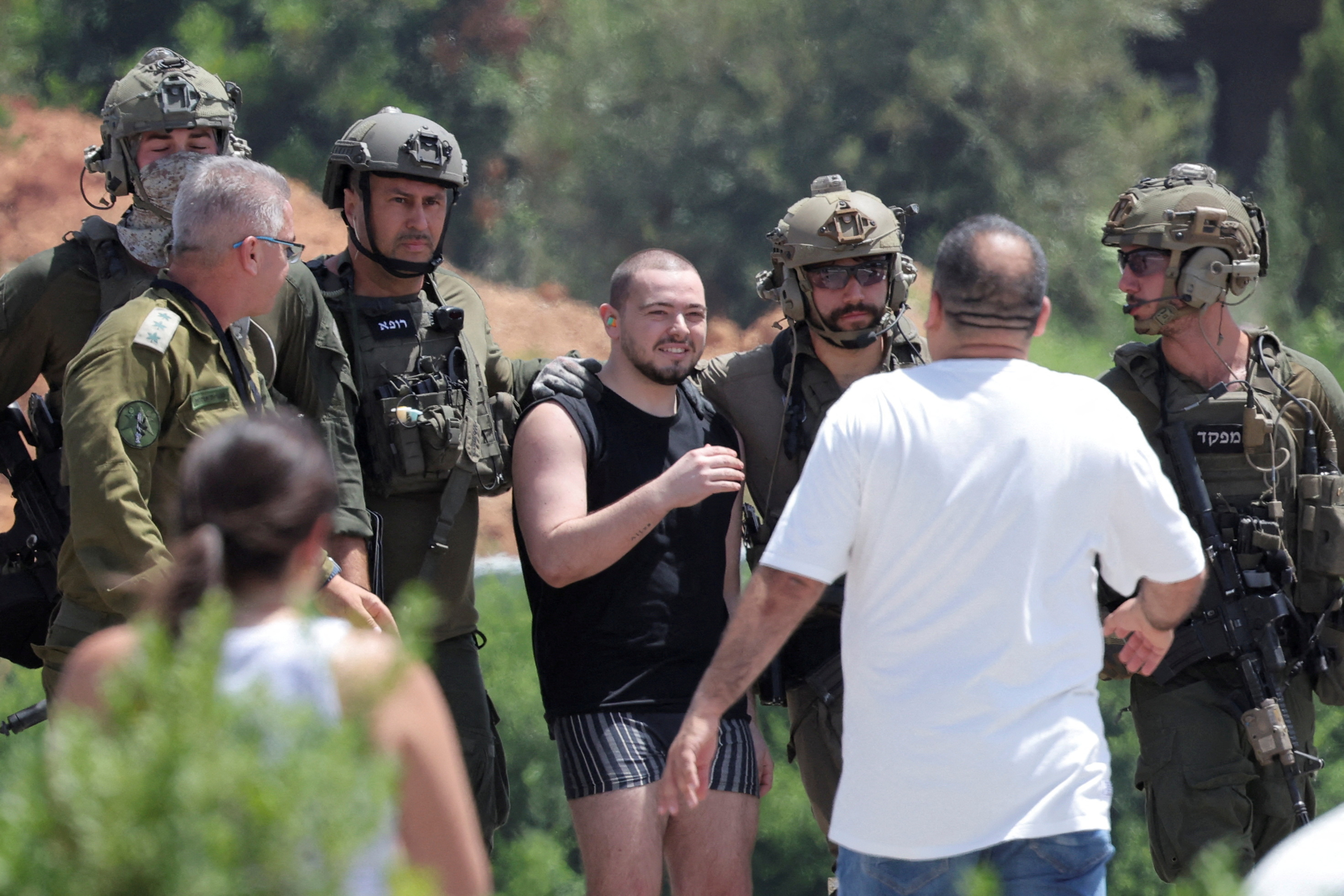 Families of hostages walk towards a hospital to meet with alleged released hostages, in Ramat Gan