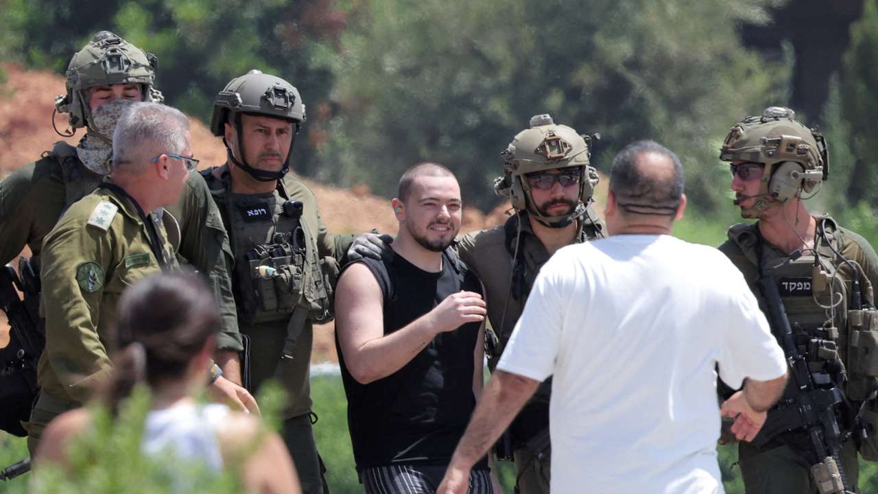 Families of hostages walk towards a hospital to meet with alleged released hostages, in Ramat Gan