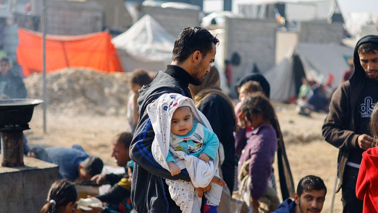 Displaced Palestinians, who fled their homes due to Israeli strikes, shelter in a tent camp in Rafah