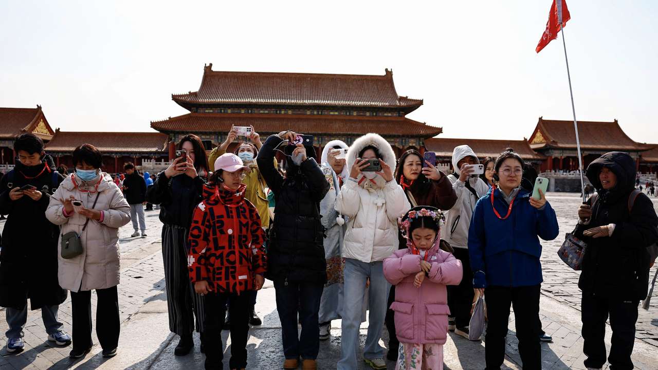 Tourists visit the Forbidden City in Beijing