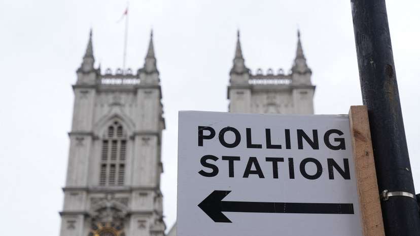Polling station direction sign is seen ahead of general elections