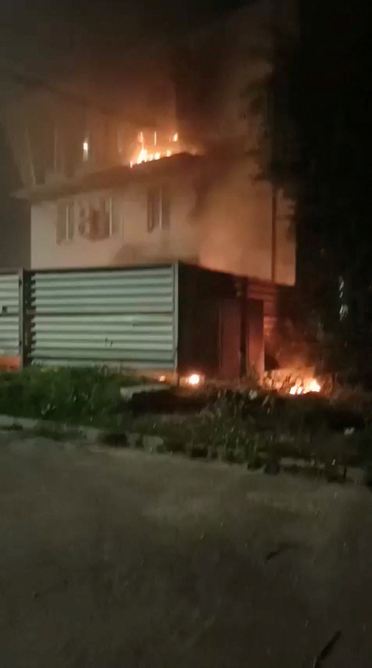 Smoke and flames rise from a building near the Archeda train station