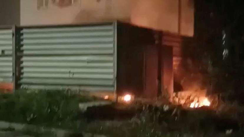 Smoke and flames rise from a building near the Archeda train station