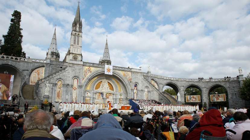 FILE PHOTO: Faithful attend a special mass for the sick celebrated by Pope Benedict XVI at the Basilica of the Rosary at the Lourdes shrine in southwestern France